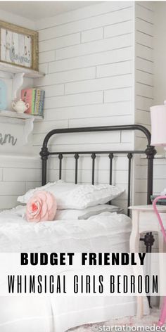 a bedroom with white brick walls and black metal bed frame, pink flower on the headboard