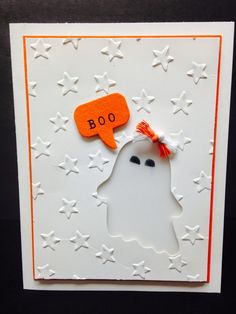 a halloween card with a ghost holding a speech bubble and the words boo written on it