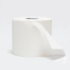 a roll of white toilet paper on a white surface with a shadow from the top