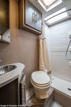 a bathroom with a sink, toilet and bathtub