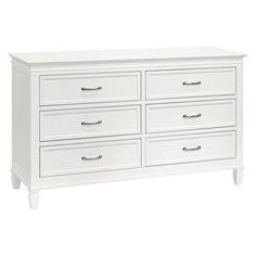 a white dresser with six drawers and two pulls on the bottom, in front of a white background