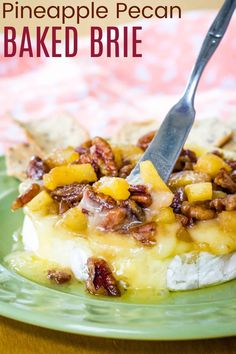 there is a piece of cake on a plate with a fork in it and the words pineapple pecan baked brie