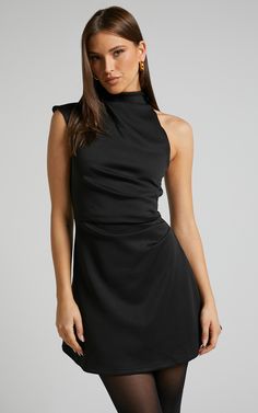 Get ready to turn heads at your next party night with the Rubie Mini Dress. This trendy one shoulder dress features a high neck and an asymmetrical hemline, giving it a unique and fashion-forward look. Made from ponte fabric, this A line dress hugs your curves in all the right places while providing comfort throughout the night. The black color adds a touch of sophistication, making it perfect for any occasion. Made from polyester, this mini dress is not only stylish but also easy to care for. P Short Black Dress Elegant, Cute Cocktail Dresses Classy, Black Dress Outfit Party Night Classy Winter, High Neck Cocktail Dress, Black Dress Colorful Accessories, Winter Little Black Dress Outfit, High Neck Dress Jewelry, Classy Christmas Dress, Rehearsal Dinner Dress For Guest Winter