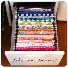 a drawer filled with lots of different colored fabrics