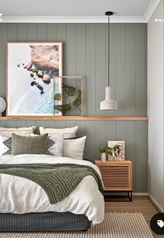 a bed sitting in a bedroom next to a wooden shelf filled with pictures on the wall