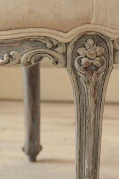 an ornately decorated bench sits on the floor