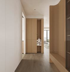 an empty room with wood flooring and white walls on either side of the room