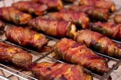 several skewered meats are being cooked on the grill