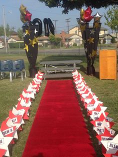 a red carpeted aisle with star decorations on it and the number ten sign in the background