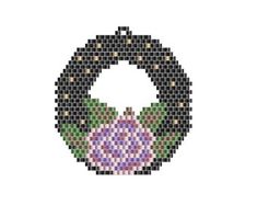 a cross - stitch ornament in the shape of a wreath