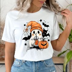 Cute Ghost Shirt, Halloween Ghost Pumpkin Spice Latte Tshirt, Spooky Season Shirt, Womens Halloween Gifts, Cute Fall Shirt, Fall Coffee Tee 👉HOW TO ORDER👈 1️⃣ Please review all the information provided before placing an order 2️⃣ Select the shirt type and size using the drop down menu. 3️⃣ Select the color of the shirt using the following drop down menu. 4️⃣ Need more Items? Add the current item in the cart. And If you like to add more items to your order please press the back button and repeat steps 1-3 again. 5️⃣ Once all your desired items are in your cart you may complete your order by entering your payment method, desired shipping address and click submit. 👉SIZING👈 If you are unsure about the size you should order, please refer to the size chart in the pictures. 👉PROCESSING TIME? White Short Sleeve Top For Halloween, Casual White Shirt For Halloween, Cute White Tops For Halloween, White Cartoon Print Halloween Top, Spooky Short Sleeve T-shirt For Fall, Spooky Fall T-shirt Pre-shrunk, Cute Halloween Cartoon Print T-shirt, Cute Halloween T-shirt With Short Sleeves, Cute Orange Halloween T-shirt