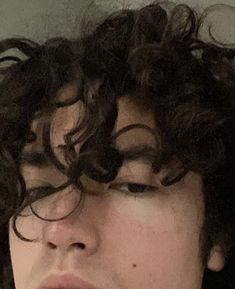 a close up of a person with curly hair