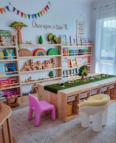 a child's playroom with toys and bookshelves