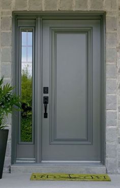 a gray front door with a potted plant next to it