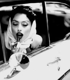 a woman is sitting in the back seat of a car