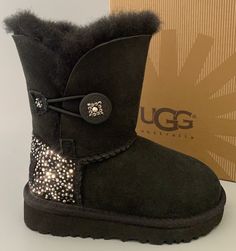 Brand: UGG Australia Condition: New with Box - Buyer will receive boots displayed in listing pictures. Model: UGG BAILEY BUTTON boots custom Embellished with beautiful Swarovski Crystals Style: #5991T Color: Black Swarovski Color: Cosmo Jet- Dove Pearl- Hematite pearl- Hematite- Black Diamond- Silver Shadow- Crystal Clear Material: Suede TODDLER Size: US7T see pictures for measurements All merchandise is guaranteed authentic. See hologram label bottom left boot tag -size labels have been marked Button Boots, Boots Ideas, Indoor Outdoor Slippers, Ugg Bailey Button, Ugg Bailey, Outdoor Slippers, Girls Boots, Ugg Australia, Suede Boots