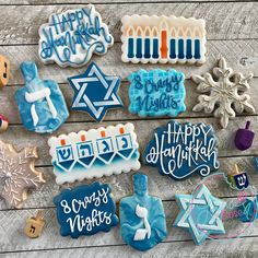 decorated cookies are laid out on a wooden table with hanukkah candles and decorations