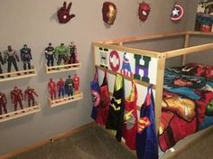 there are many toy action figures on the shelves in this room, including captain america and iron man