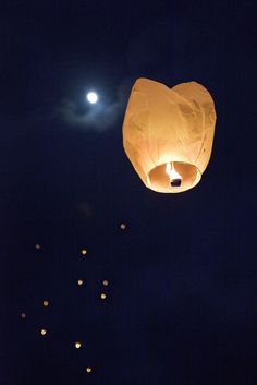 a sky lantern floating in the air at night