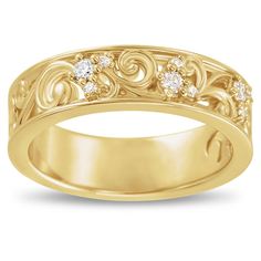 a yellow gold wedding ring with diamonds on the sides and an intricate design in the middle