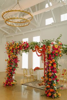 an arrangement of flowers and greenery decorates the ceremony space