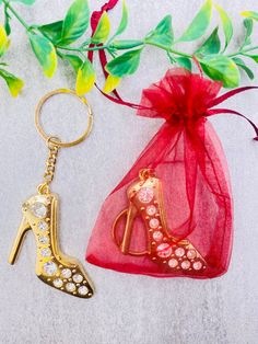 two keychains, one with a high heel and the other with a bag