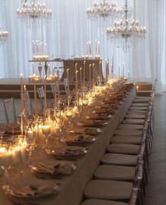 a long table is set up with candles and place settings for an elegant dinner party