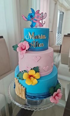 a three tiered cake decorated with flowers and hearts