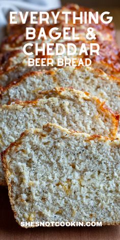 several slices of bread sitting on top of a cutting board with the words everything bagel beer bread