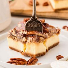 a piece of pecan cheesecake on a white plate with a fork in it