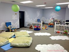 a child's playroom with lots of toys on the floor and large rugs