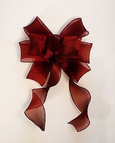 a red bow is hanging on the wall