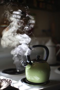 a tea kettle with steam rising from it