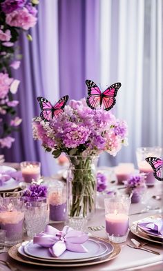 the table is set with purple flowers, candles and butterfly centerpieces in vases