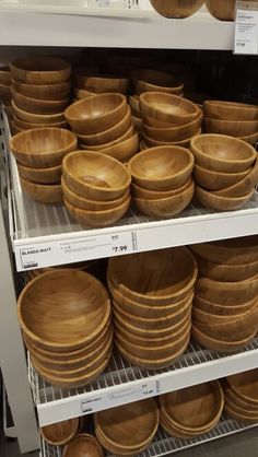 wooden bowls and plates on shelves in a store