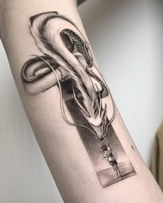 a black and white photo of a dragon tattoo on the right arm with an arrow in it's center