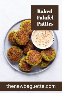 baked falafel patties on a plate with dipping sauce in the middle