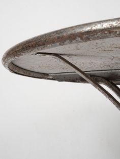 a close up of a metal object on a white background