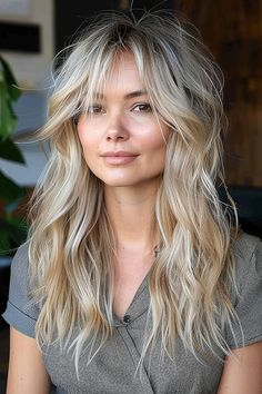 A woman with an effortless blonde long shag hairstyle and natural volume. Long Blond Shaggy Hair, Long Shag With No Bangs, 70s Inspired Haircut Long, Long Shag Haircut Straight Hair No Bangs, Blonde Textured Hair, Shag Hairstyles Medium Blonde, Shag Haircut With Side Part, Shag Hairstyles Long Fine Hair, Women’s Long Hair Shag