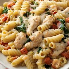 a white bowl filled with pasta and chicken