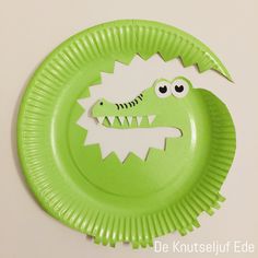 a paper plate with a green monster face on it