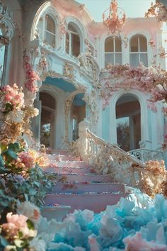 an elaborately decorated building with pink and blue flowers on the steps in front of it