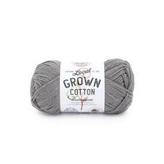 the yarn ball is gray and has a white label on it that says crown cotton