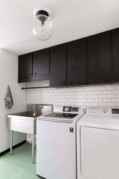 a washer and dryer in a small room with green carpeting on the floor