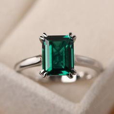 This ring features a 7*9mm emerald cut lab emerald and sterling silver finished with rhodium. Customization is available. It is made by hand, and it will take about 7 days to finish the ring after your payment is completed. It include the lab emerald ring and the band. Main stone: lab emerald Main stone weight: Approx 2.06 ct Metal type: sterling silver finished with rhodium/14k white gold/14k rose gold/14k yellow gold Accent stone: none Customization is available, I also can make it with 14k so Silver Ring With Emerald Stone, Emerald White Gold Ring, Silver Emerald Engagement Ring, Wedding Ring Emerald Cut, Wedding Ring Emerald, Wedding Rings Emerald Cut, Green Diamond Rings, Silver Emerald Ring, Prong Engagement Rings