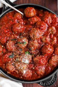 a skillet filled with meatballs and marinara sauce