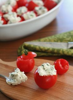 tomatoes and cheese are sitting on a cutting board