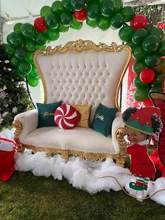 an elaborately decorated couch and chair in the middle of a lawn with balloons on it