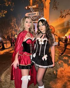 two women dressed in costumes standing next to each other