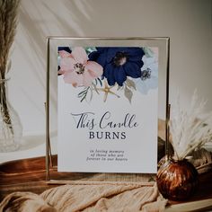 a card that says this candle burns on it next to some feathers and a vase